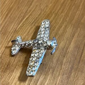 Vintage airplane brooch covered in rhinestones